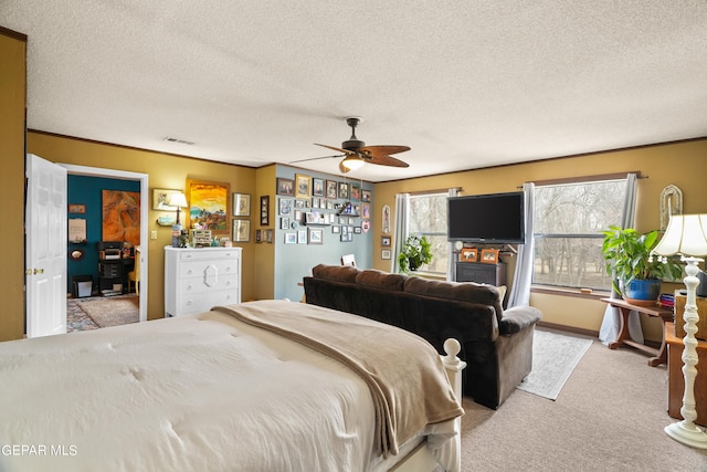 carpeted bedroom with ceiling fan and a textured ceiling