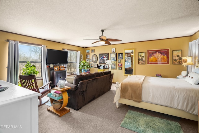 bedroom with carpet, ceiling fan, and a textured ceiling