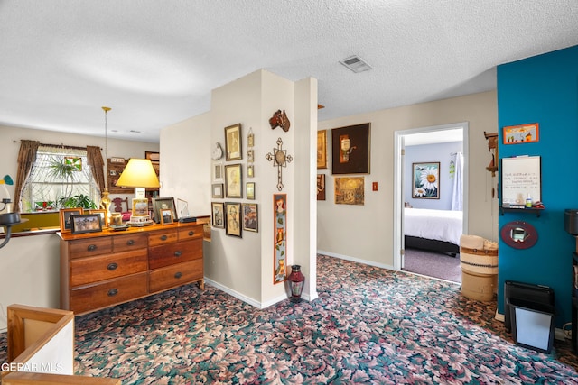 carpeted bedroom featuring a textured ceiling