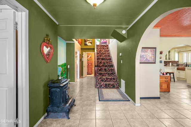 exterior space featuring ornamental molding, sink, and a wood stove