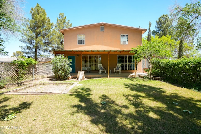 back of house featuring a lawn