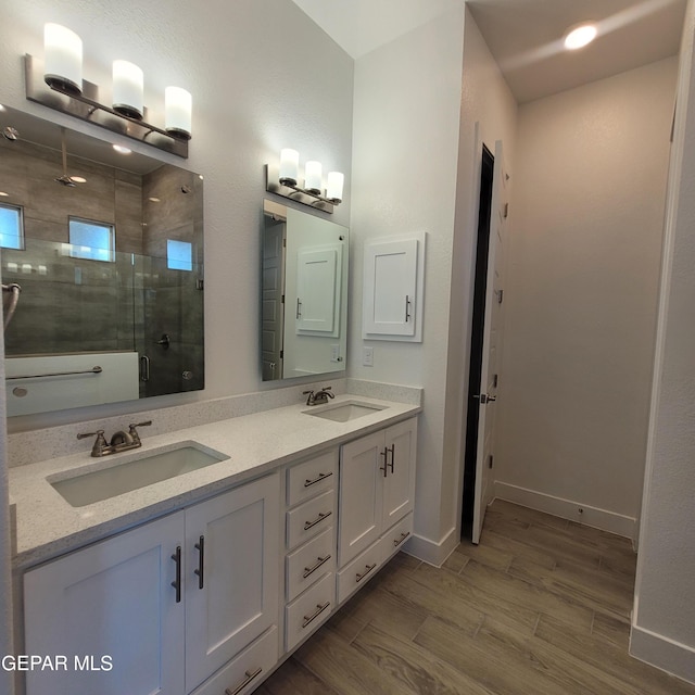 bathroom featuring vanity, hardwood / wood-style flooring, and an enclosed shower