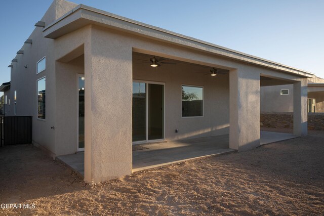 back of house with ceiling fan and a patio