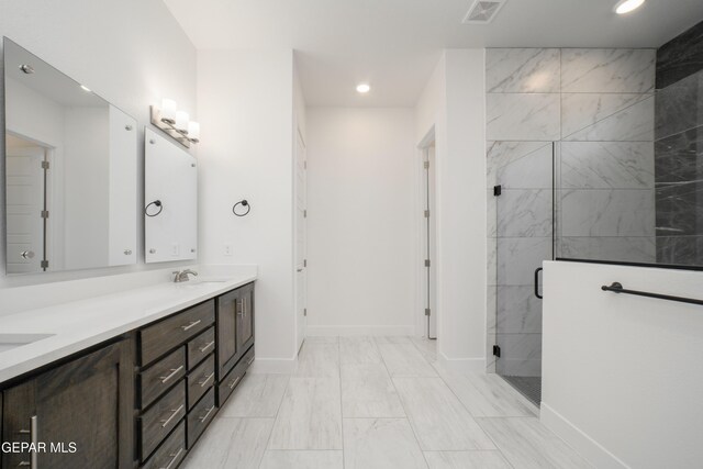 bathroom with vanity and a shower with shower door