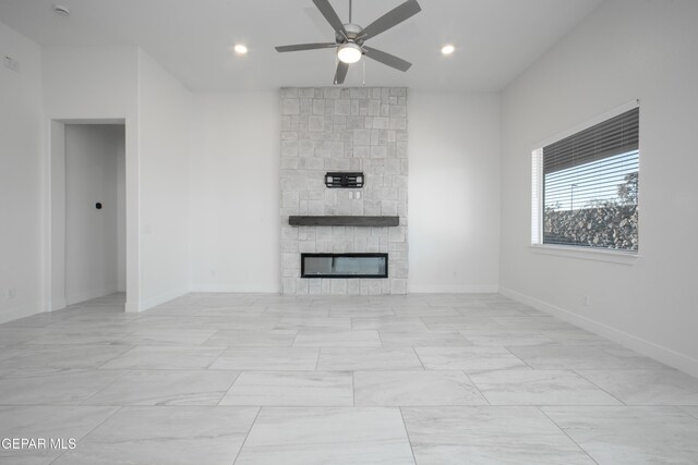 unfurnished living room featuring a fireplace and ceiling fan