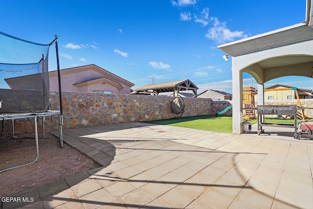 view of patio / terrace featuring a playground and a trampoline