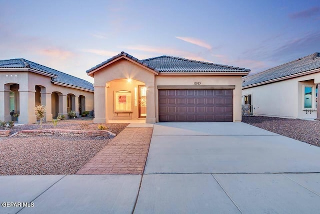 mediterranean / spanish house with a garage