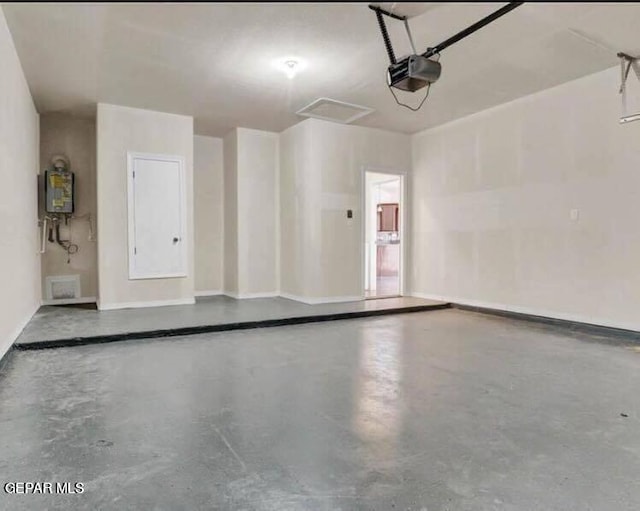 garage featuring water heater and a garage door opener