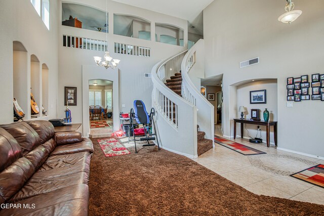 tiled living room with an inviting chandelier and a towering ceiling