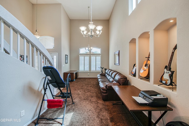 foyer with carpet, a chandelier, and a high ceiling