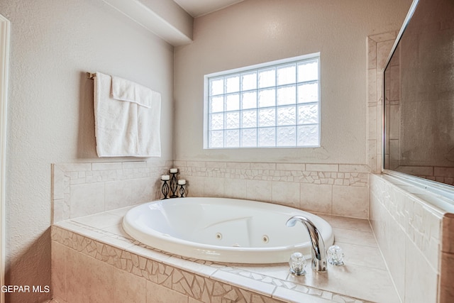 bathroom with a relaxing tiled bath