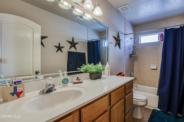 full bathroom with shower / bath combination with curtain, vanity, tile flooring, toilet, and a textured ceiling