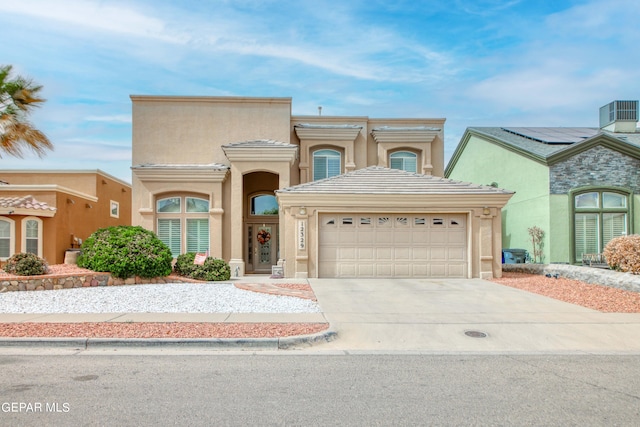 view of front of property featuring a garage and solar panels