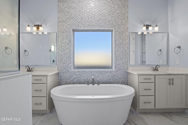 bathroom featuring a washtub, double vanity, and tile floors