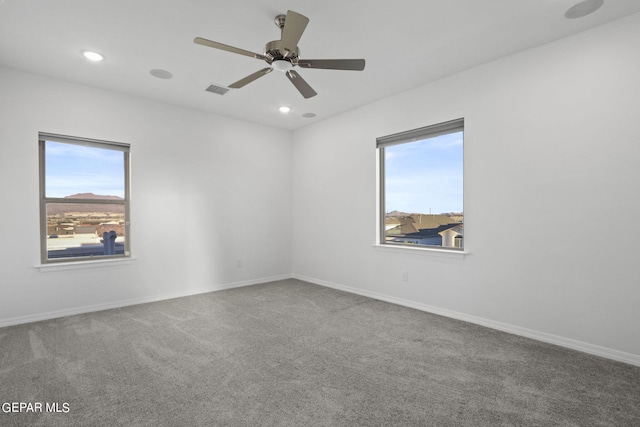 carpeted empty room featuring ceiling fan