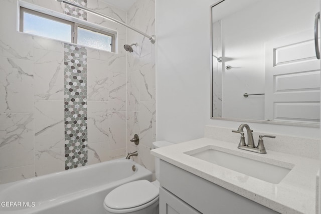 full bathroom featuring tiled shower / bath combo, vanity, and toilet