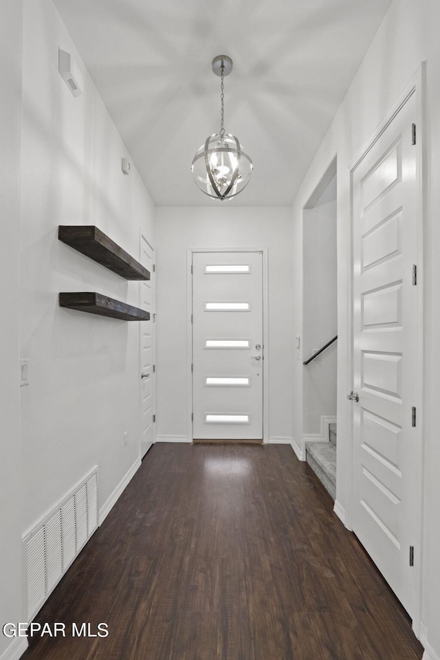 entryway featuring dark hardwood / wood-style flooring and a notable chandelier