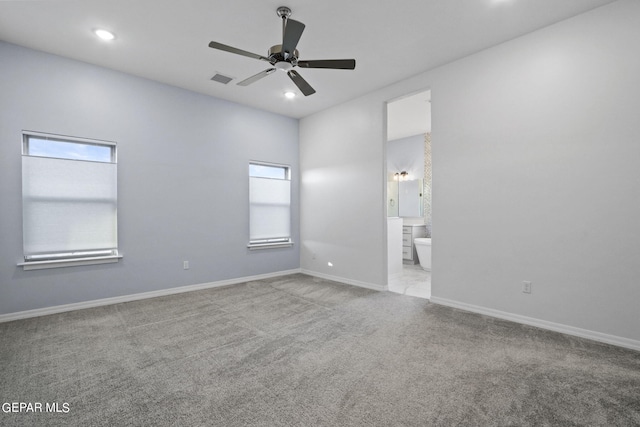 tiled spare room featuring ceiling fan and a healthy amount of sunlight