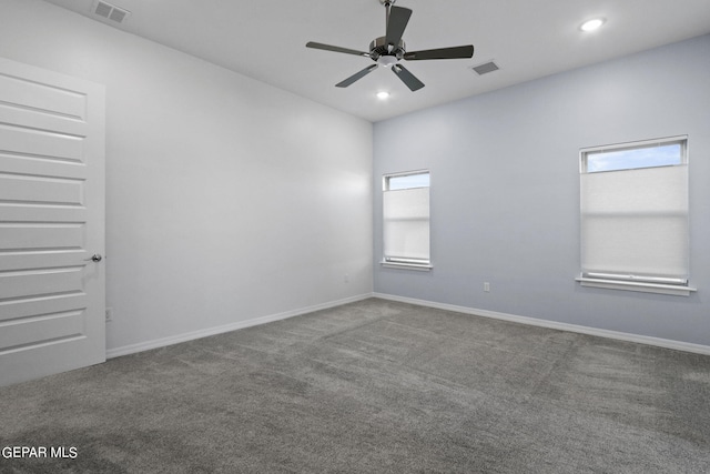 empty room with plenty of natural light, carpet floors, and ceiling fan