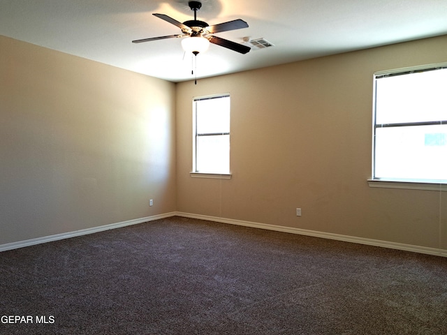 carpeted empty room featuring ceiling fan