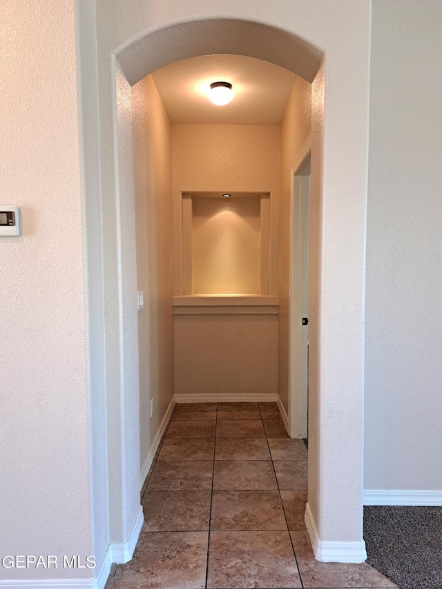 hallway with tile flooring