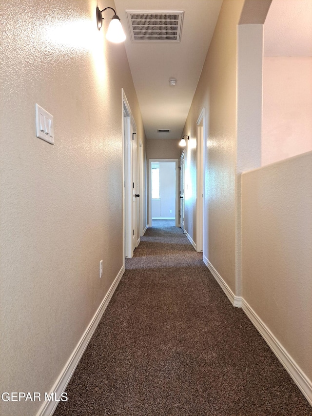 hall with dark carpet