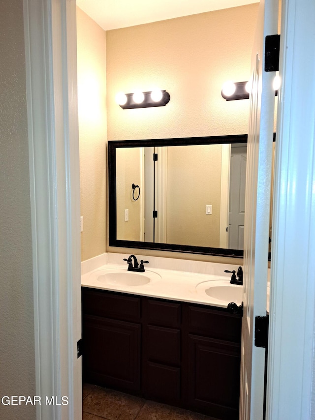 bathroom featuring tile floors and double sink vanity