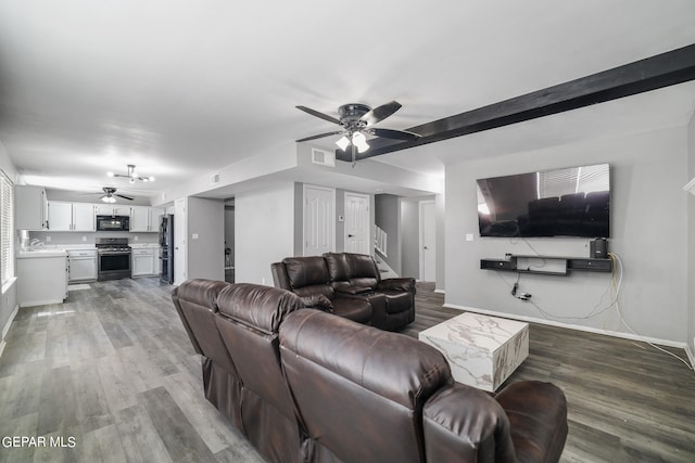 living room with wood-type flooring, ceiling fan, and sink