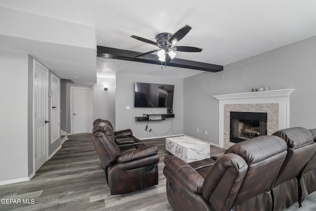 living room with hardwood / wood-style flooring, beamed ceiling, and ceiling fan