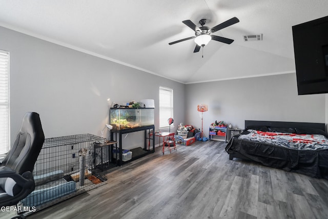 bedroom featuring wood-type flooring, lofted ceiling, ceiling fan, and ornamental molding