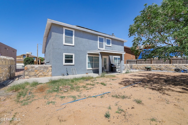 back of house with a patio