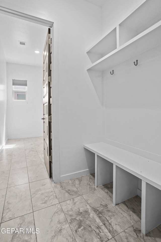 mudroom featuring light tile floors