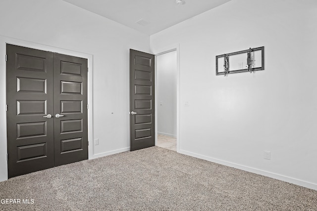 unfurnished bedroom featuring a closet and carpet floors