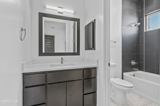 full bathroom with tiled shower / bath, toilet, tile floors, and vanity