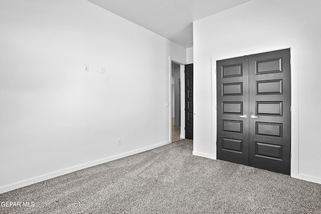 unfurnished bedroom with a closet and carpet floors