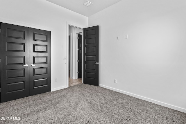 unfurnished bedroom with a closet and carpet