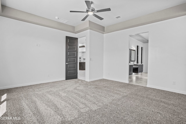 carpeted spare room featuring ceiling fan