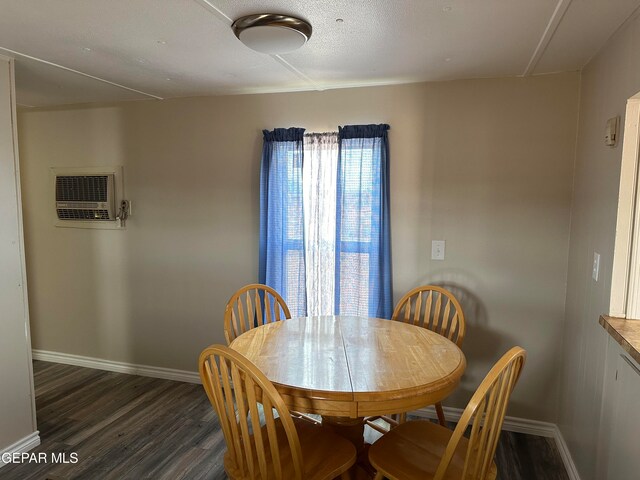 dining area featuring a wall mounted AC and dark hardwood / wood-style floors