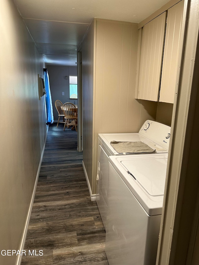 washroom featuring washer and dryer, dark hardwood / wood-style flooring, and cabinets