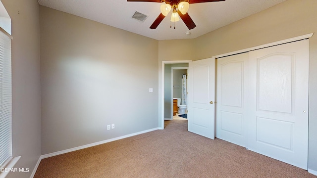 unfurnished bedroom with a closet, carpet, and ceiling fan