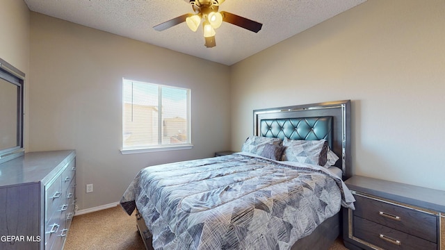 carpeted bedroom featuring ceiling fan and a textured ceiling