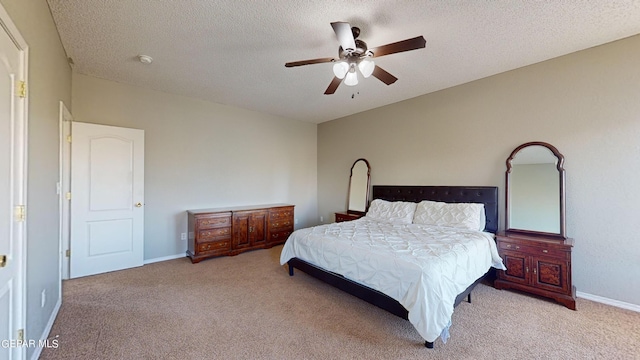 carpeted bedroom with a textured ceiling and ceiling fan