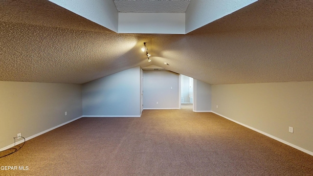 bonus room with carpet, a textured ceiling, and lofted ceiling