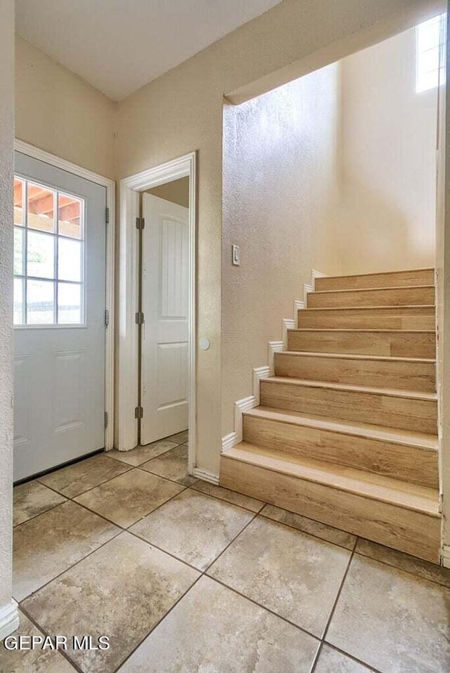 foyer entrance featuring light tile floors