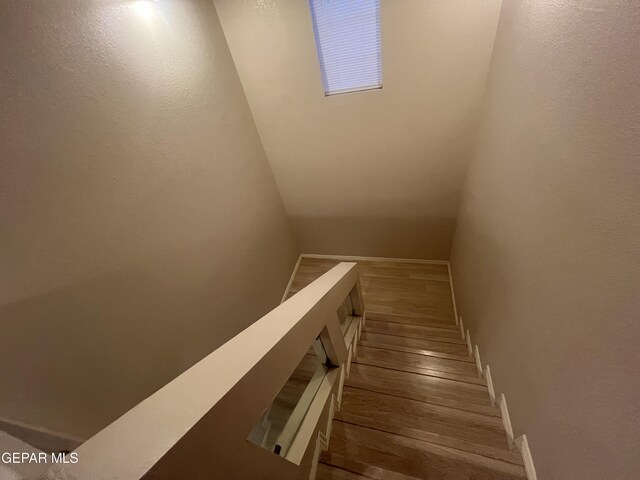 stairs featuring hardwood / wood-style flooring