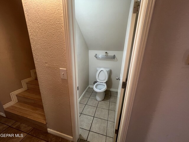 bathroom featuring tile floors and toilet