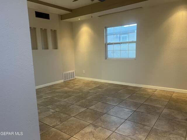 tiled empty room with ceiling fan