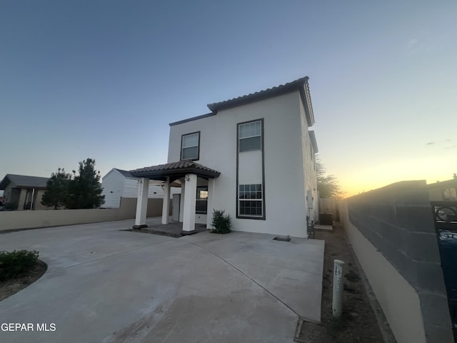 mediterranean / spanish house with a patio