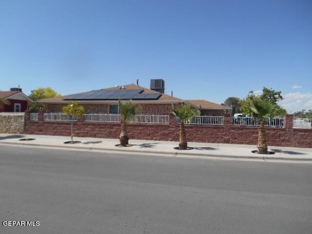 view of front facade featuring solar panels