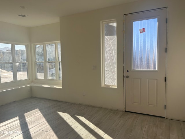 entrance foyer featuring visible vents and wood finish floors